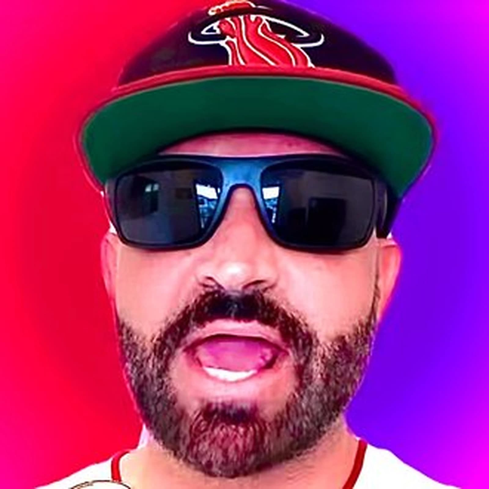 JuruPicks wearing sunglasses and a Miami Heat cap